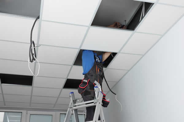 Commercial Electrician working in office